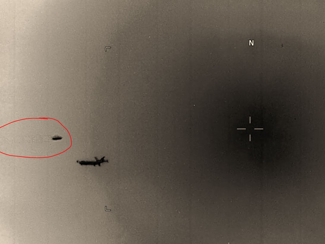 AARO sensor frame — circled UAP adjacent to commercial aircraft with crosshair targeting and "N" compass marker. From the April 2023 SASC briefing.