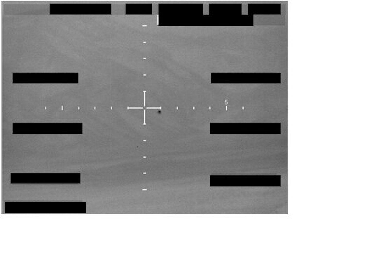 FBI Photo A1: monochrome sensor capture with central crosshair reticle and a small dark object below and right of center